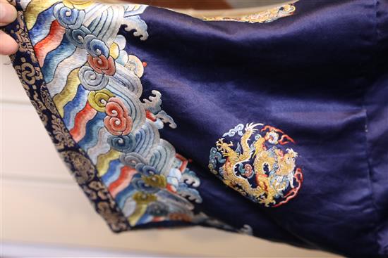 A Chinese noblewomans embroidered silk midnight blue surcoat (longgua), late 19th century, 138cm long, minor alterations to sleeves an
